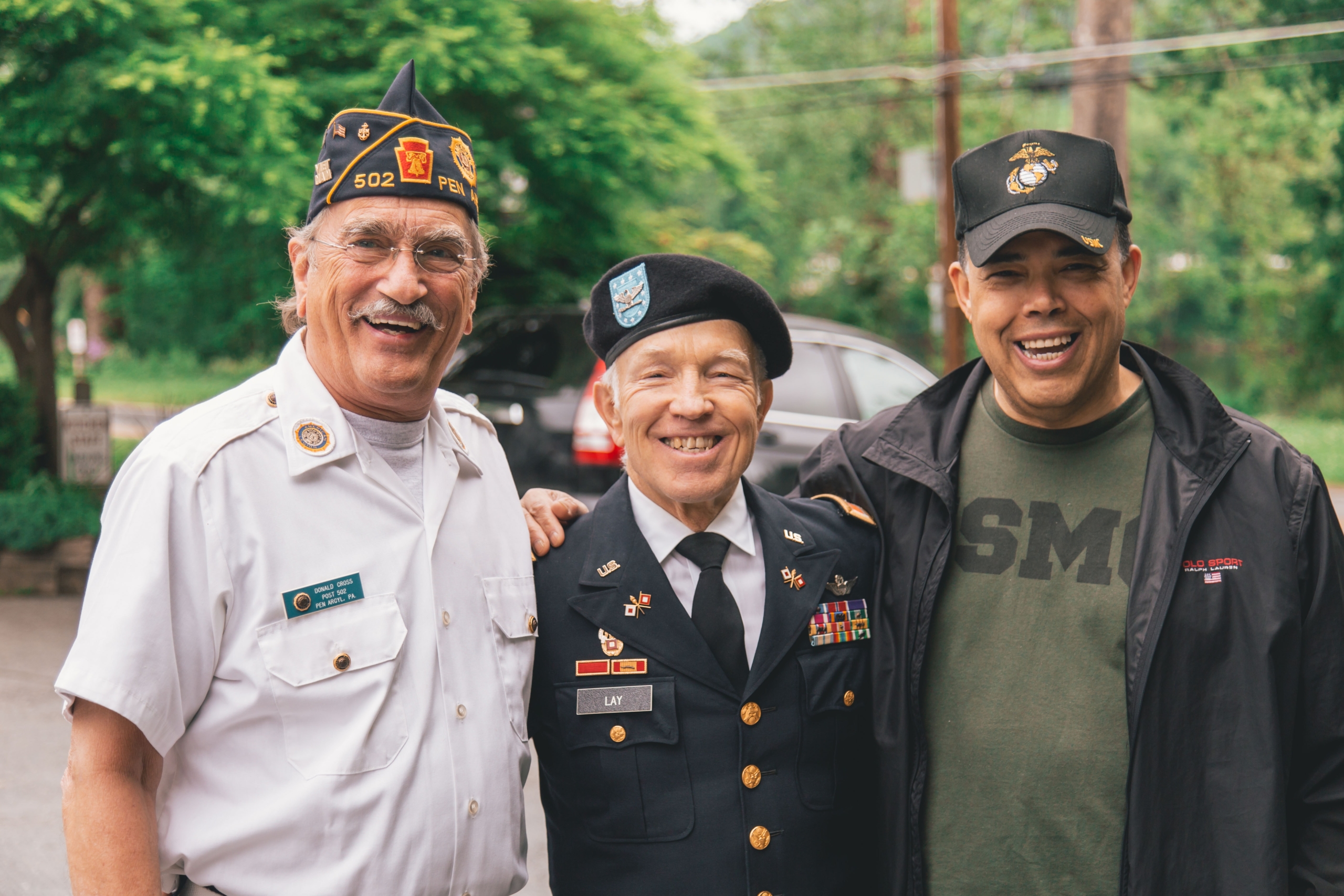 three elderly veterans standing together