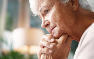 Senior woman, unhappy and thinking in home